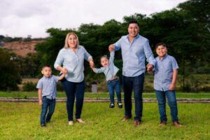 Family of five in matching outfits enjoying a sunny day outdoors.